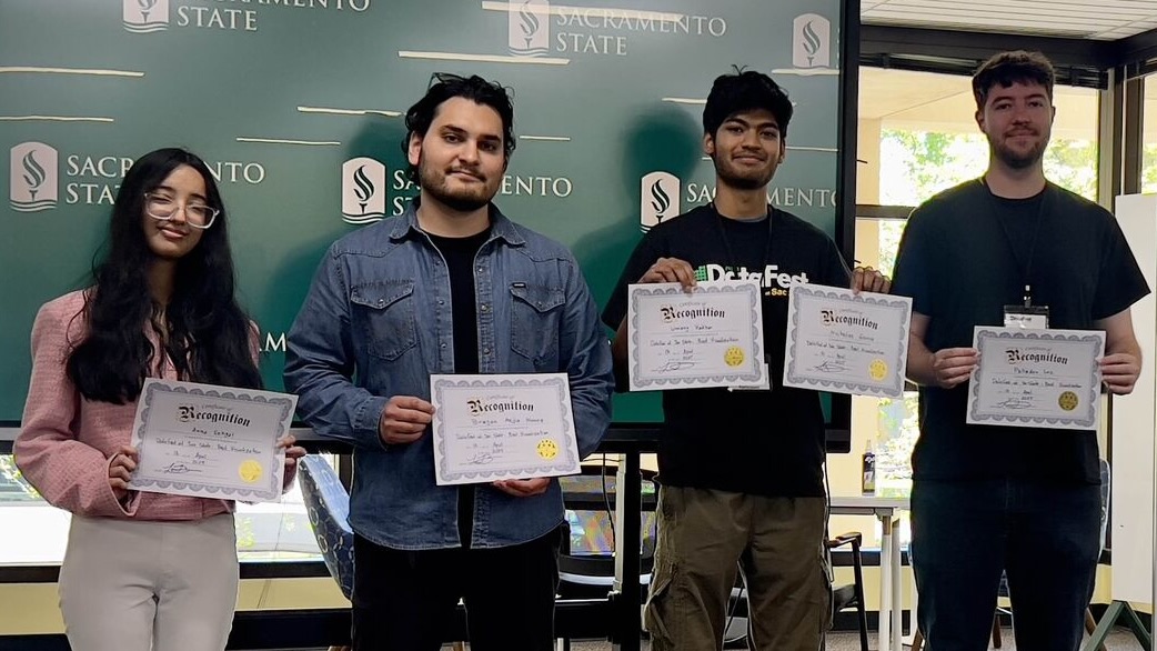 Image of Anna Segal, Brayan Mejia Nunez, Umang Vadher, and Palladen Lee accepting the award for best visualization at Data Fest.